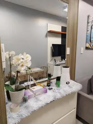 a counter with flowers and other items on it at ck staycation coast residence in Manila