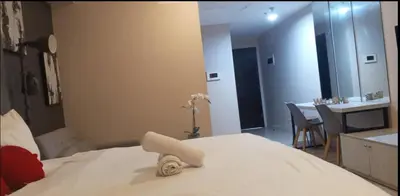 a hotel room with a bed and a sink and a table at JRM Staycation Naia T3 in Manila