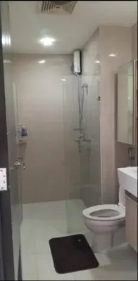 a bathroom with a shower and a toilet and a sink at JRM Staycation Naia T3 in Manila