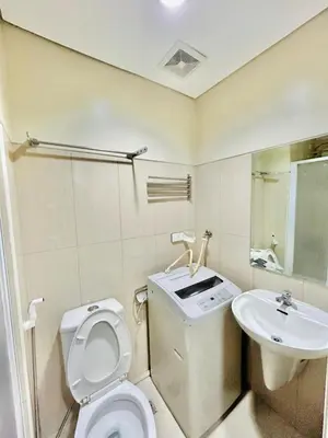 a bathroom with a toilet and a sink at 1Bedroom Pool View - MOA Shell Residences Near Airport in Manila