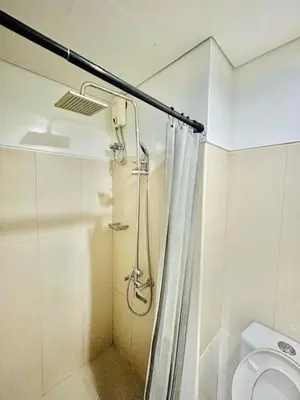 a bathroom with a shower and a toilet at 1Bedroom Pool View - MOA Shell Residences Near Airport in Manila
