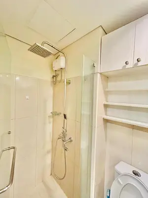 a bathroom with a shower and a toilet at 1Bedroom Pool View - MOA Shell Residences Near Airport in Manila