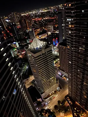 an aerial view of a city at night at City chic in the heart of Makati #4609 in Manila