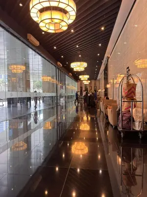 a lobby with chairs and people in a building at City chic in the heart of Makati #4609 in Manila