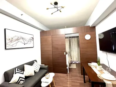 a living room with a couch and a table at City chic in the heart of Makati #4609 in Manila
