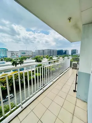a balcony with a view of a city at SGG Place 2 Bedroom Shell Residences Mall of Asia Near NAIA in Manila