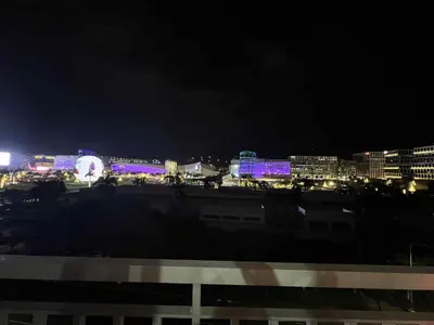 a city lit up at night with buildings at SGG Place 2 Bedroom Shell Residences Mall of Asia Near NAIA in Manila