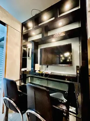 a meeting room with chairs and a flat screen tv at 1BR Affordable Room infront of Mall of Asia Near Airport in Manila