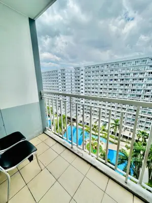 a balcony with a view of a building at SGG Place Deluxe Room- MOA Shell Residences Near NAIA in Manila