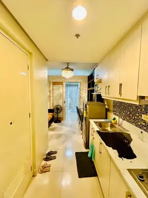 a kitchen with a sink and a counter top at SGG Place Deluxe Room- MOA Shell Residences Near NAIA in Manila