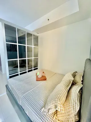 a bedroom with a bed with a book on it at SGG Place Deluxe Room- MOA Shell Residences Near NAIA in Manila