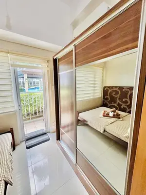 a small room with a bed and a window at SGG Suite Room Pool View - Shell Residences MOA Pasay Near NAIA in Manila