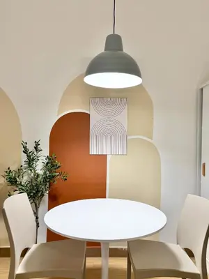a dining room with a white table and chairs at Meraki Stays - ETANA - SMDC Hope Residences in Trece Martires