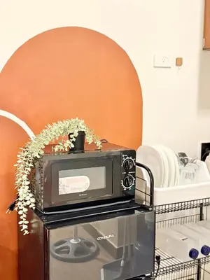 a microwave sitting on top of a table at Meraki Stays - ETANA - SMDC Hope Residences in Trece Martires