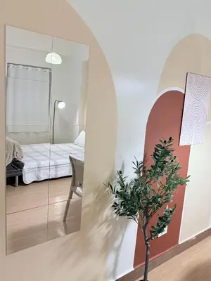 a room with a mirror and a bedroom with a bed at Meraki Stays - ETANA - SMDC Hope Residences in Trece Martires