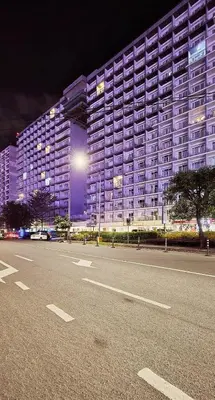 a large building with a parking lot in front of it at SGG Manila 2Bedroom MOA View - Shell Residences MOA Near Airport in Manila