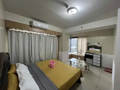 a bedroom with a bed and a glass table at SGG Manila 2Bedroom MOA View - Shell Residences MOA Near Airport in Manila