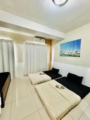 a bedroom with two beds in a room at SGG Manila 2Bedroom MOA View - Shell Residences MOA Near Airport in Manila