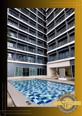 a large swimming pool in front of a building at Celebrity Haven in Manila
