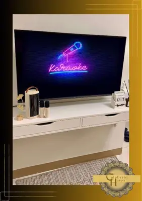 a flat screen tv sitting on top of a dresser at Celebrity Haven in Manila