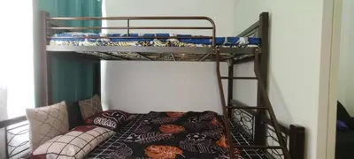 a bunk bed in a room with a couch at La Casa Celiacay in Sangley Point Naval Station