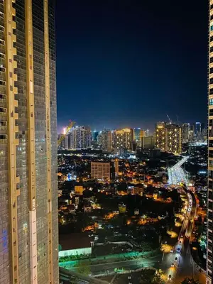 a view of a city at night with buildings at BGC Cosy Nest Uptown Parksuites Tower 1 Near Nice Restaurants and Malls in Manila