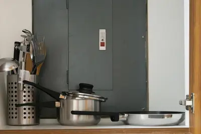 a stove top with a pot and a bowl at 2br Forbeswood Heights in BGC near St Lukes in Manila