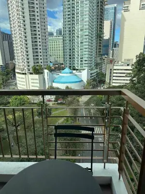a balcony with a bench and a view of a city at Cozi Makati Executive Studio balcony in Manila