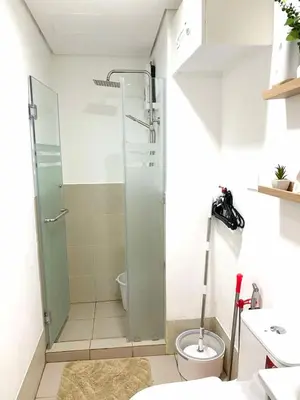 a bathroom with a shower and a toilet at The Hive Staycation - SMDC Hope Residences in Trece Martires
