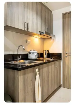 a kitchen with a sink and a counter top at S-Residence Staycation IKEA,MOA,PICC in Manila