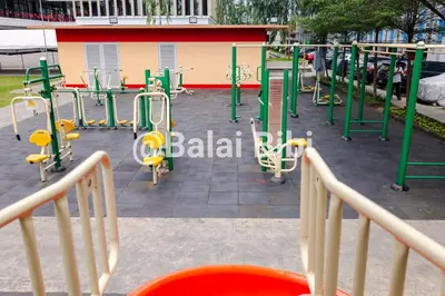 a playground with green and yellow equipment in a park at Balai Bibi at Urban Deca Homes Ortigas 3Br in Manila