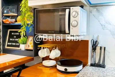a kitchen with a counter top with a microwave at Balai Bibi at Urban Deca Homes Ortigas 3Br in Manila