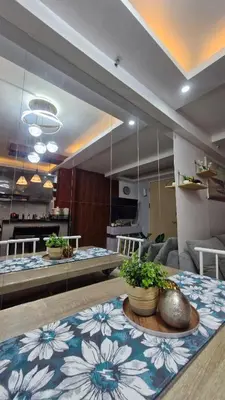 a room with a table with plants on it at Cozy RC 2BR w loft Netflix Prime KTV Games in Manila