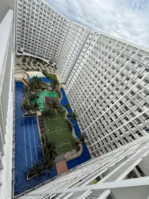 an overhead view of a large building with a pool at 2BR SHORE FAMILY GROUPs AFFORDABLE STAYCATION in Manila