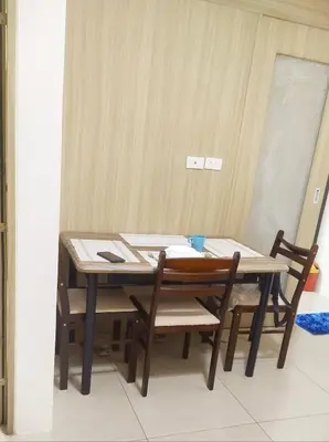 a wooden table with two chairs and a table and a table at 2BR SHORE FAMILY GROUPs AFFORDABLE STAYCATION in Manila
