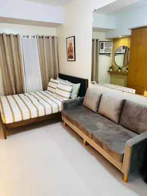 a living room with two couches and a couch at Unit 23L T-B The Pearl Place Ortigas in Manila