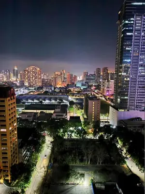 a view of a city at night with buildings at Unit 23L T-B The Pearl Place Ortigas in Manila