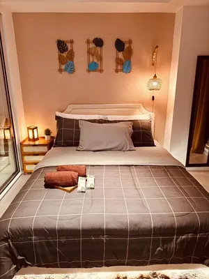 a bedroom with a large bed with two towels on it at Azure Urban Resort-The Rustic Escape in Manila