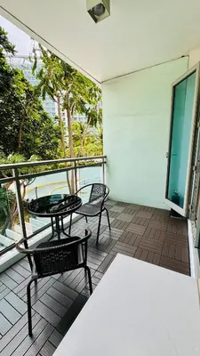 a patio with a table and chairs on a balcony at Azure Urban Resort-The Rustic Escape in Manila