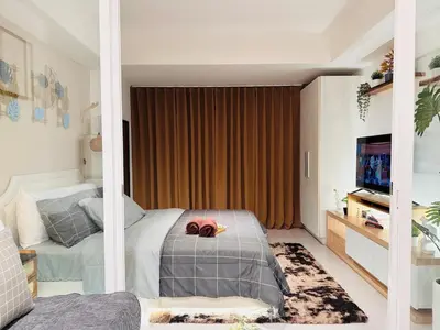 a bedroom with a bed and a television in it at Azure Urban Resort-The Rustic Escape in Manila