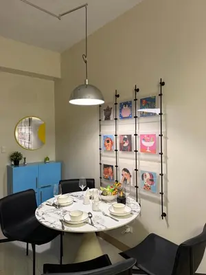 a dining room with a table and chairs at Playful 1BR With Magnificant Bayview Garden View Near Okada, Solaire, Aiports in Manila