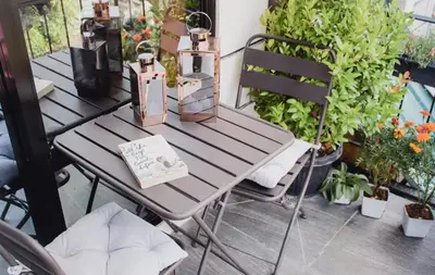a table and chairs on a patio with plants at Modern Chic Retreat in Antipolo