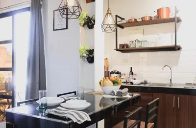 a kitchen with a table with a bowl of fruit on it at Modern Chic Retreat in Antipolo