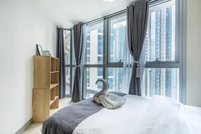 a bedroom with a large window with a swan on the bed at Uptown Parksuites Sky Garden Flr Bright Airy 2 BR balcony in Manila