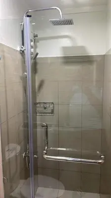 a shower with a glass door in a bathroom at Shore 2 Tower 3 1BR 15th Floor Near SMX MOA in Manila
