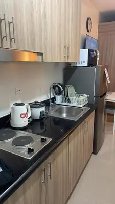 a kitchen with a sink and a counter top at Shore 2 Tower 3 1BR 15th Floor Near SMX MOA in Manila