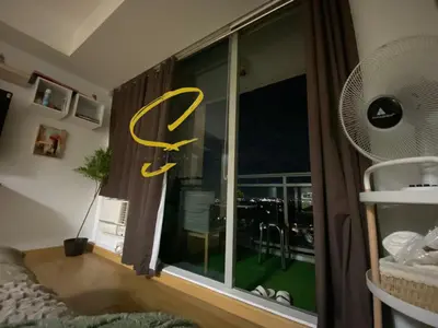 a room with a window with a large yellow sign on it at Azure staycation by Scarlet Suites in Manila