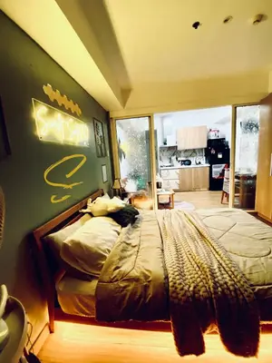 a bedroom with a bed with a sign on the wall at Azure staycation by Scarlet Suites in Manila