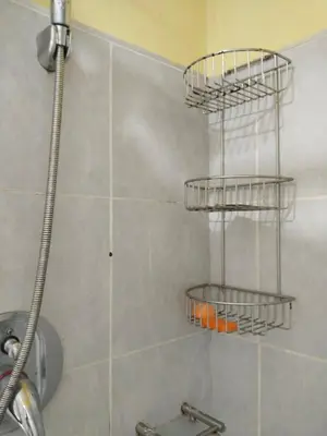 a shower with three shelves in a bathroom at MOA Sea Residences Condo in Manila