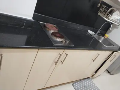 a kitchen counter top with a sink and a sink at MOA Sea Residences Condo in Manila